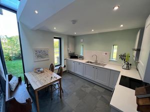modern-kitchen-with-white-cupboards-and-slate-tile-floor.jpg