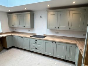 kitchen-with-wooden-counters-and-sage-green-cupboards.jpg