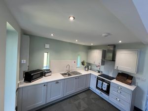 new-kitchen-with-white-units-and-olive-green-walls.jpg