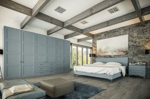 Bedroom with wooden beamed ceiling and grey wardrobes.