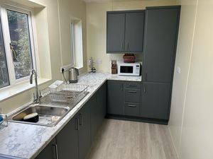 modern-kitchen-with-cream-walls-and-grey-cupboards.jpg