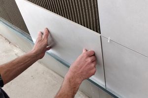 Conner Stewart fitting kitchen tiles.